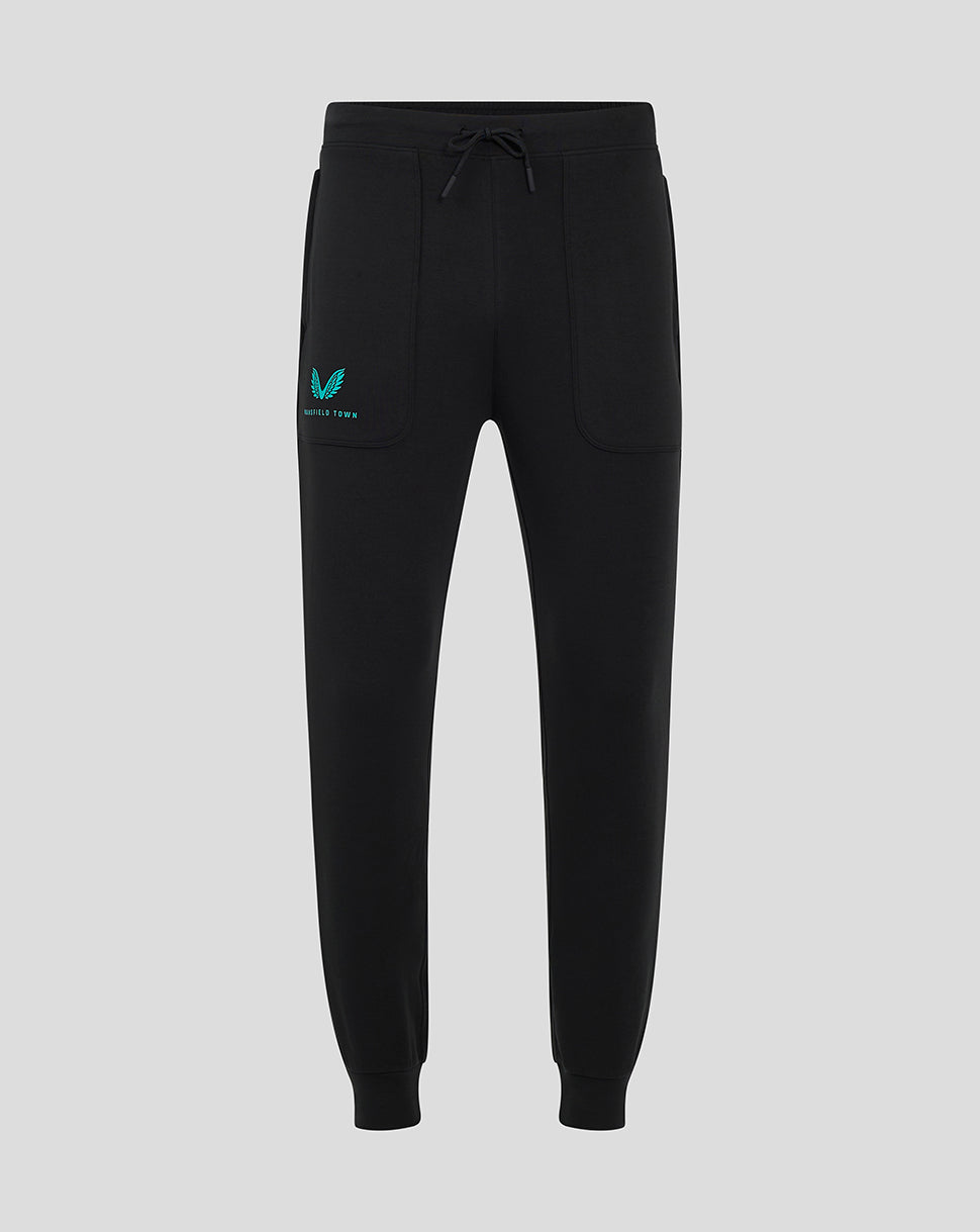 Black Mansfield travel pants with a drawstring waist and teal logo on the left thigh.