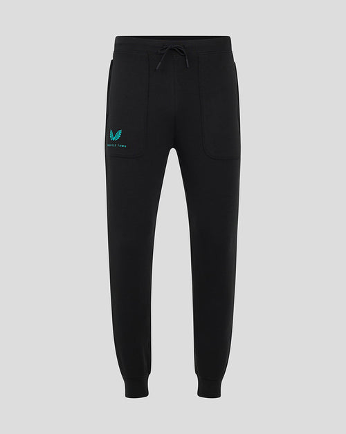 Black Mansfield travel pants with a drawstring waist and teal logo on the left thigh.