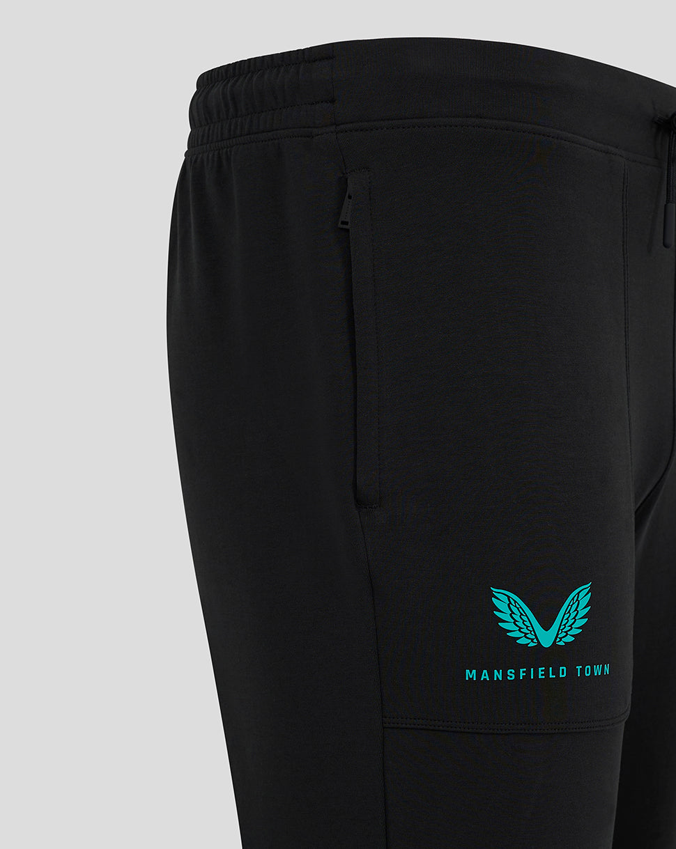 Teal Mansfield Town crest and text on calf area of black pants.