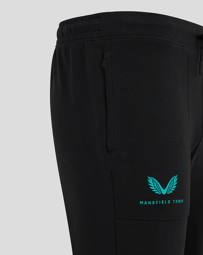Teal Mansfield Town crest and text on calf area of black pants.