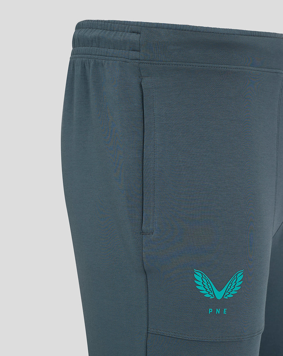 Detail of Preston NE Travel Pant featuring teal crest on right thigh and leg seams.