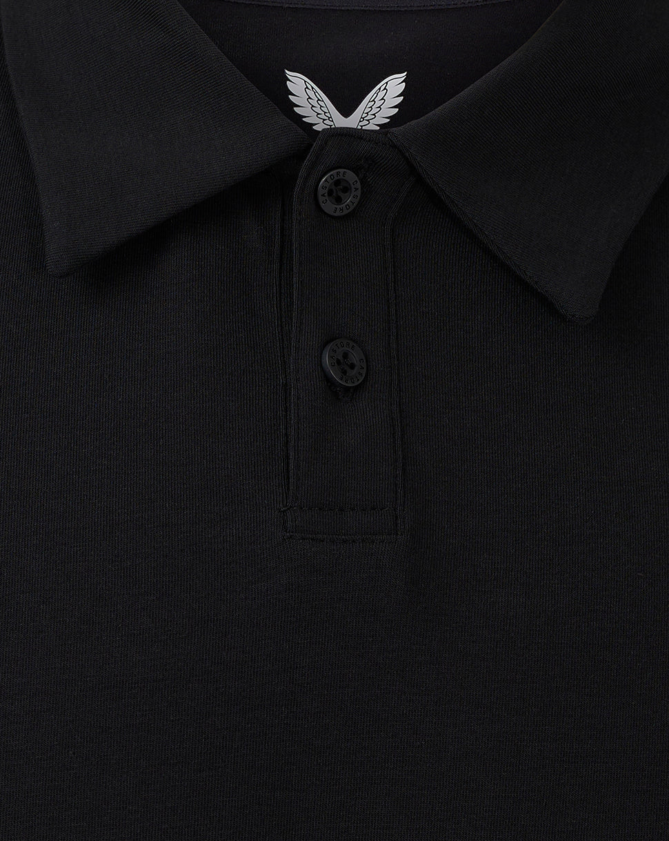Close-up of black polo collar with two-button placket and white wing emblem at the neckline.
