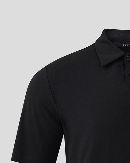 Close-up of black polo shoulder and collar with brand Castore label visible inside.