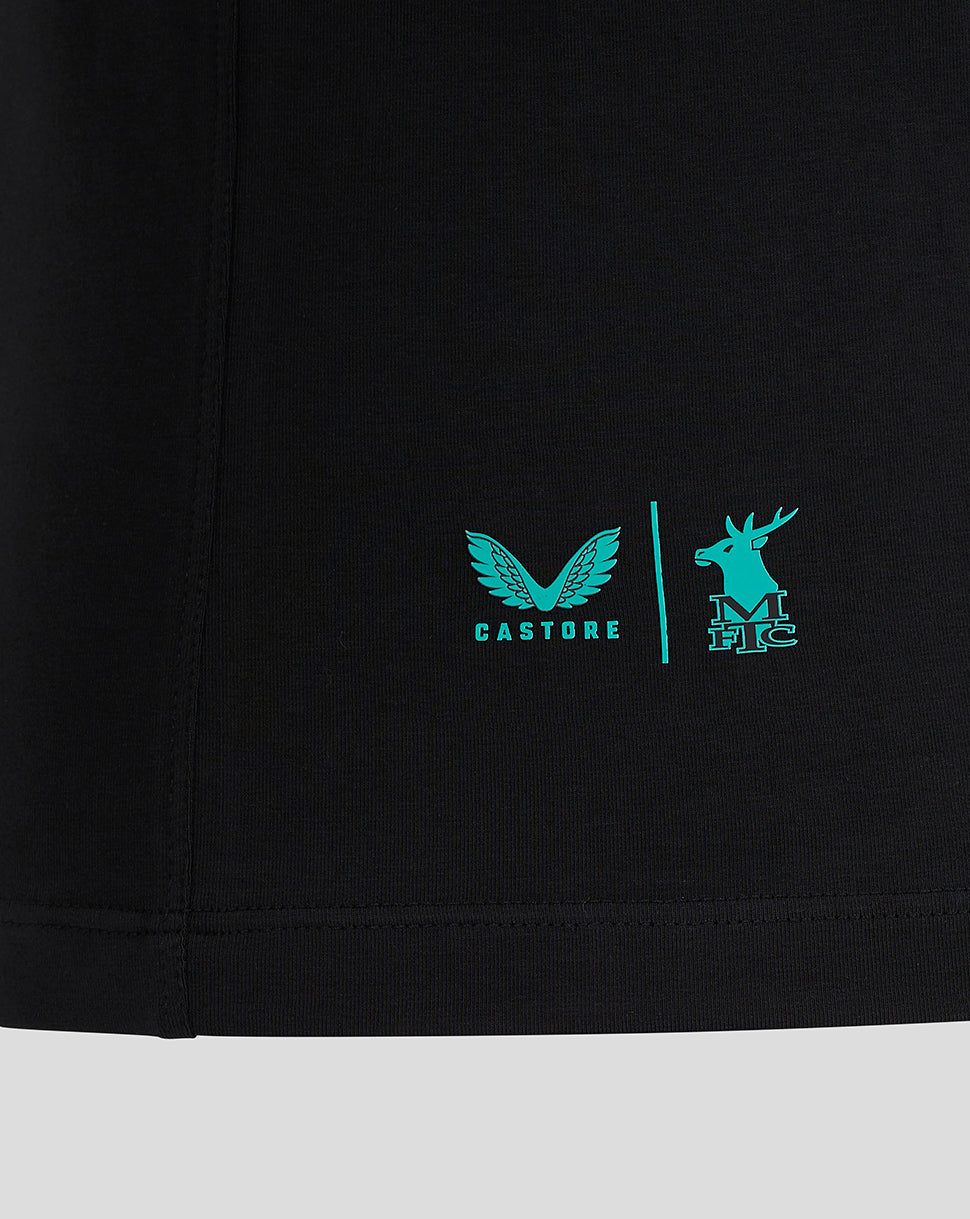 Close-up of black Mansfield Travel Polo hem with turquoise Castore logo and deer crest