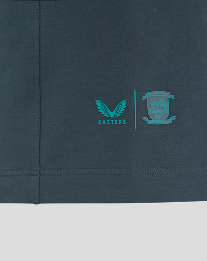 Close-up of Castore and Preston North End crest logos on the polo lower left hem