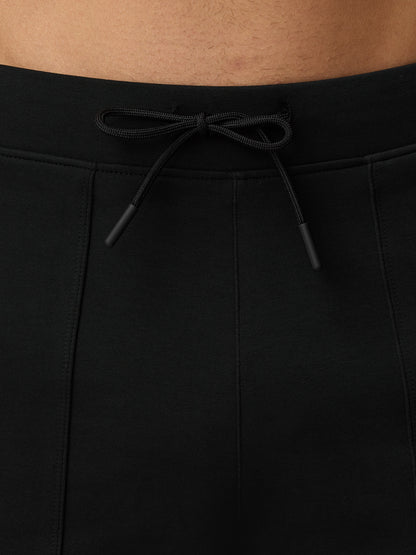 Close-up of the adjustable black drawstring at the waistband of travel shorts.