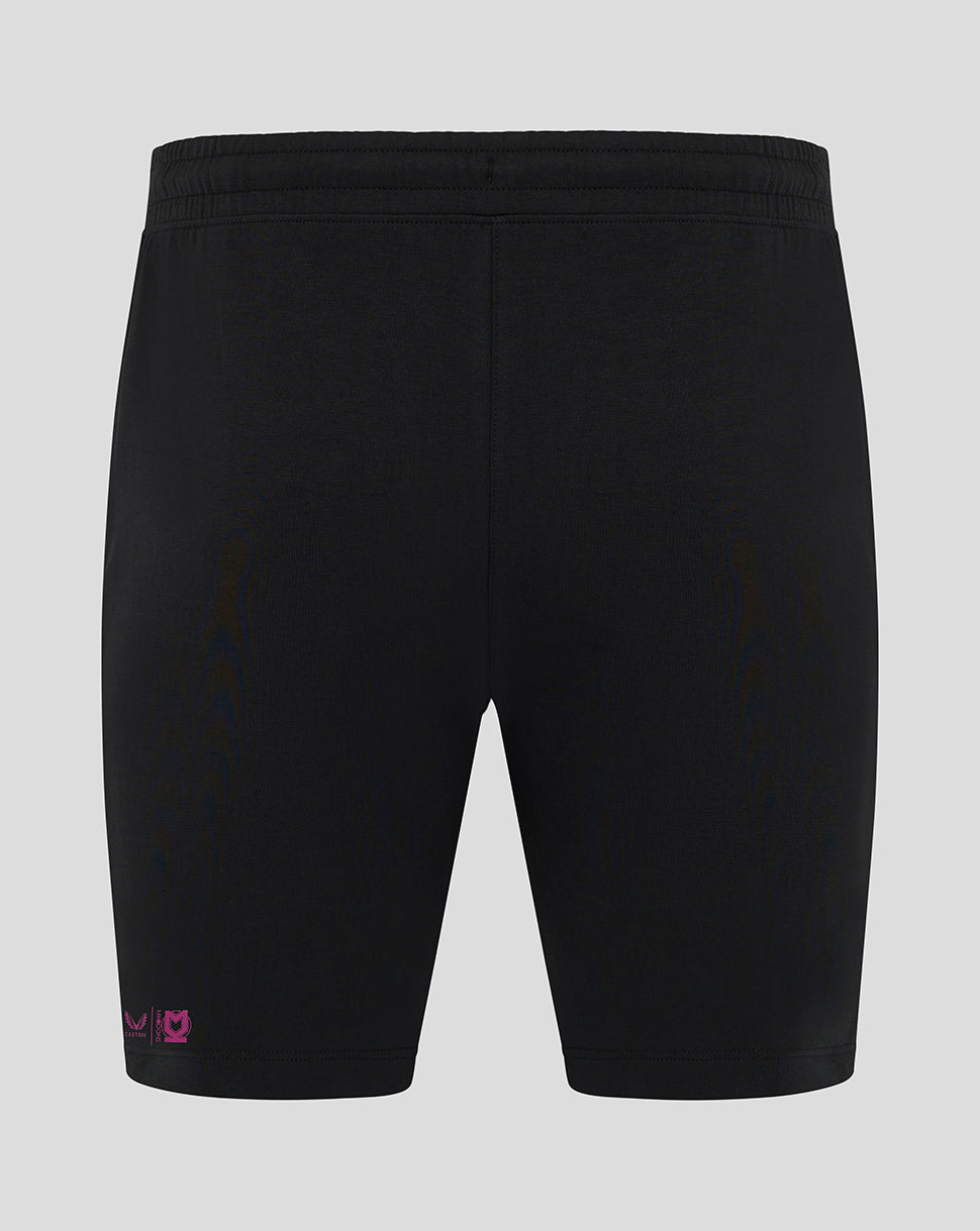 Back view of black Mk Dons travel shorts with pink logo near the hem