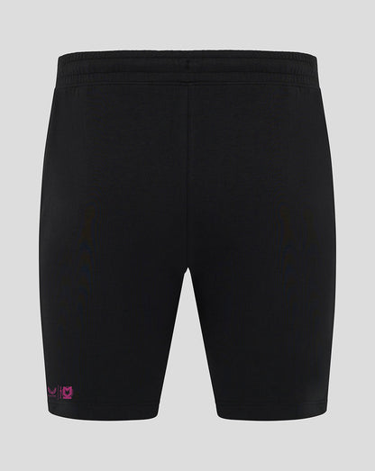 Back view of black Mk Dons travel shorts with pink logo near the hem