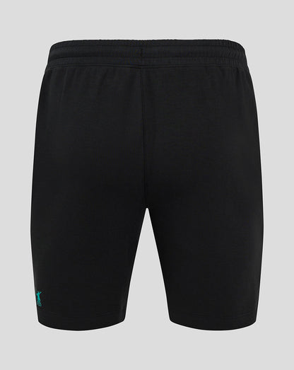 Back view of black shorts with elastic waistband and small teal logo at the lower left leg