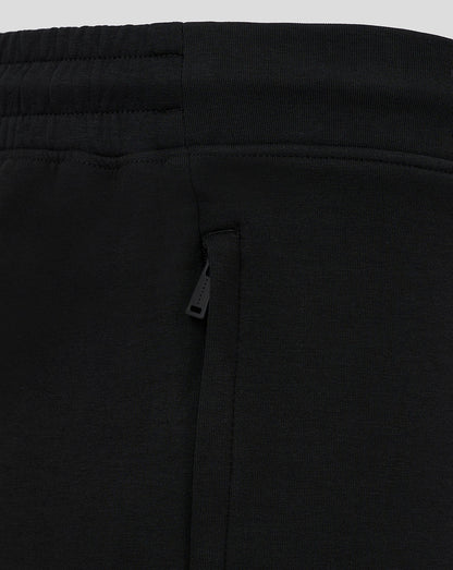 Close-up of the waistband and side zip pocket on black travel shorts.