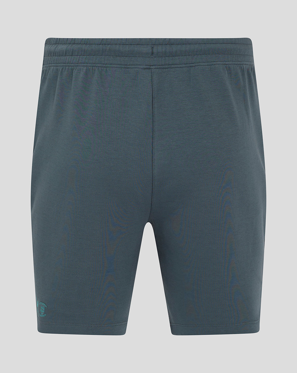 Back view of blue Preston NE Travel Shorts with a center back seam and a logo at the rear left hem