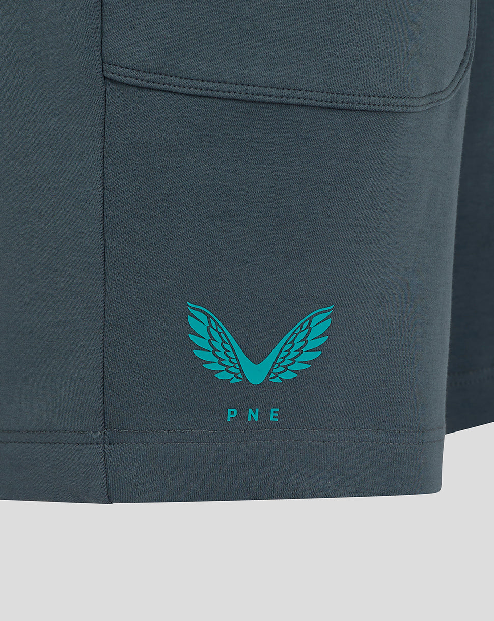Close-up of the lower left leg showing teal Castore wing logo and PNE crest on dark teal fabric.