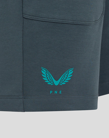 Close-up of the lower left leg showing teal Castore wing logo and PNE crest on dark teal fabric.