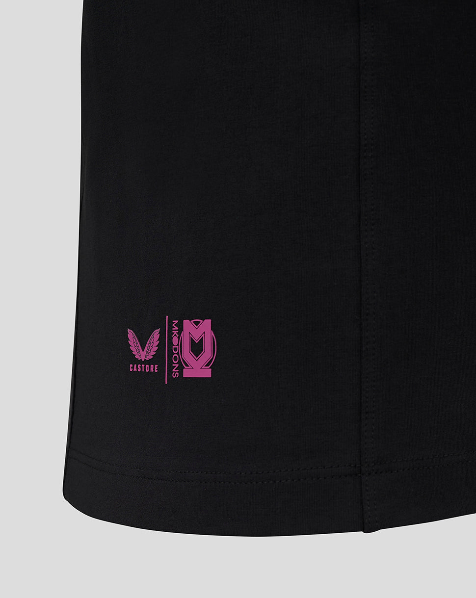 Close up of the T shirt hem showing a small pink Castore Mk Dons logo