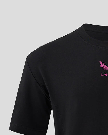 Left shoulder close up of black Mk Dons Travel T Shirt with pink wing logo on the chest