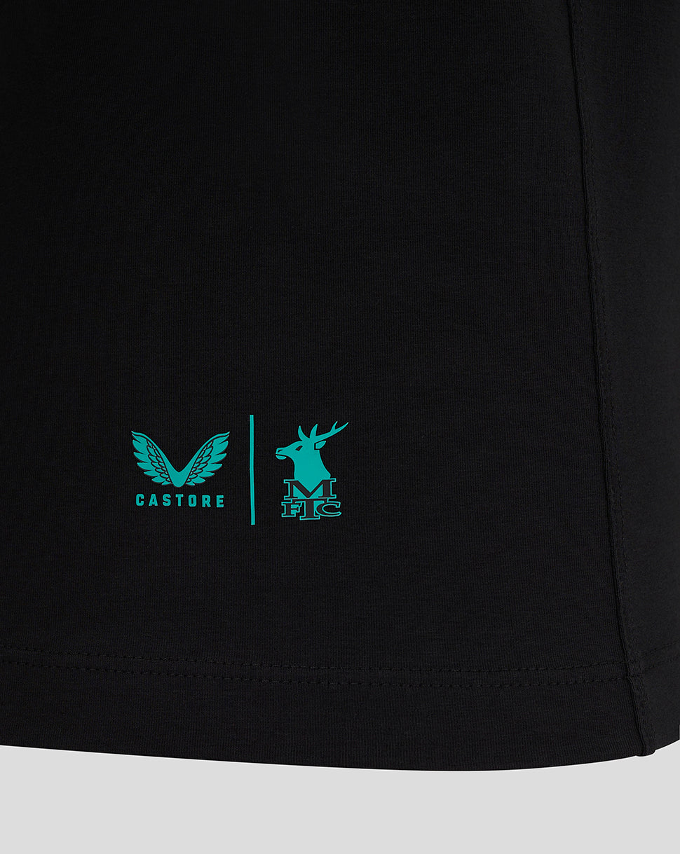 Close-up of the lower front of the black Mansfield Travel Tee showing turquoise logos and a vertical divider