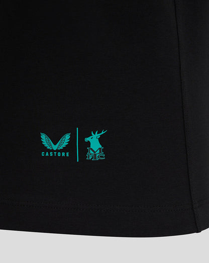 Close-up of the lower front of the black Mansfield Travel Tee showing turquoise logos and a vertical divider