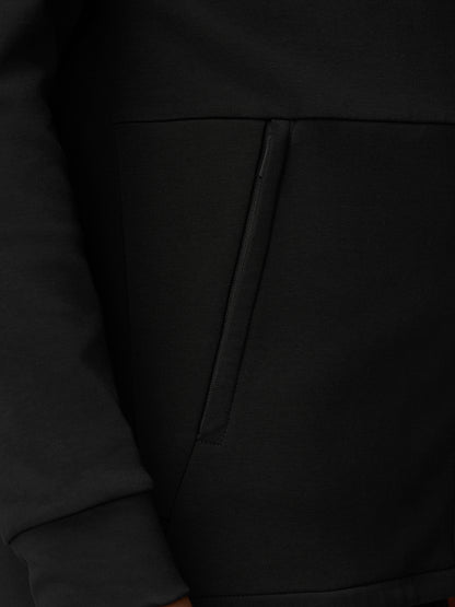 Close-up of a black Travel Full Zip Hoodie pocket with diagonal zipper detail