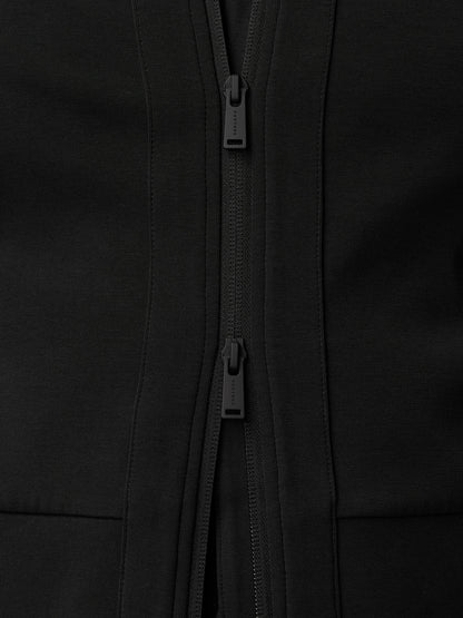 Close-up of the black travel full zip hoodie showing dual zippers and textured fabric.