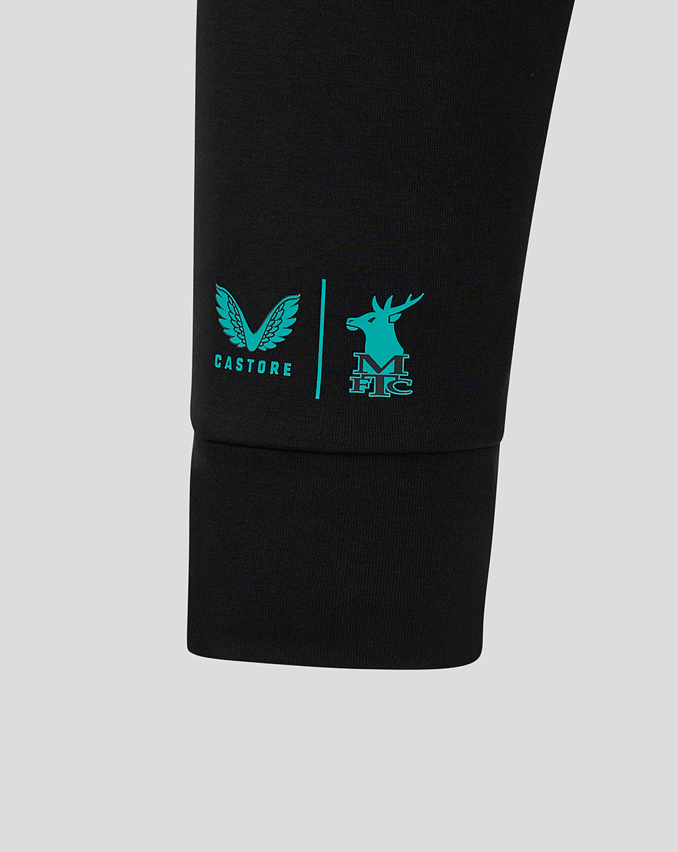 Sleeve detail on black Mansfield jacket showing teal Castore logo and deer crest near cuff