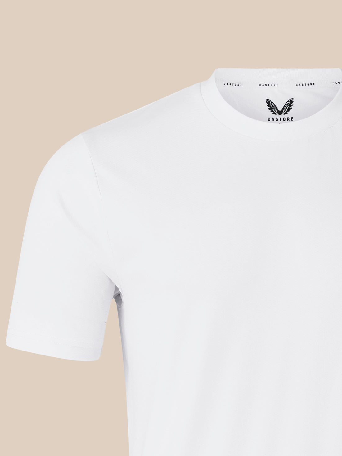 Shoulder and sleeve close-up of white short sleeve T shirt against beige background.