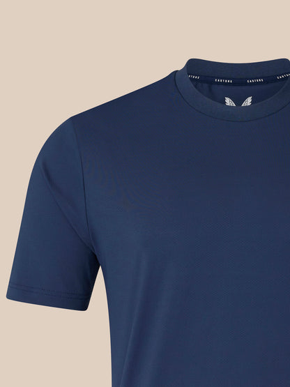 Close up of navy men's short sleeve T shirt showing white crest logo on left chest and ribbed crew neck