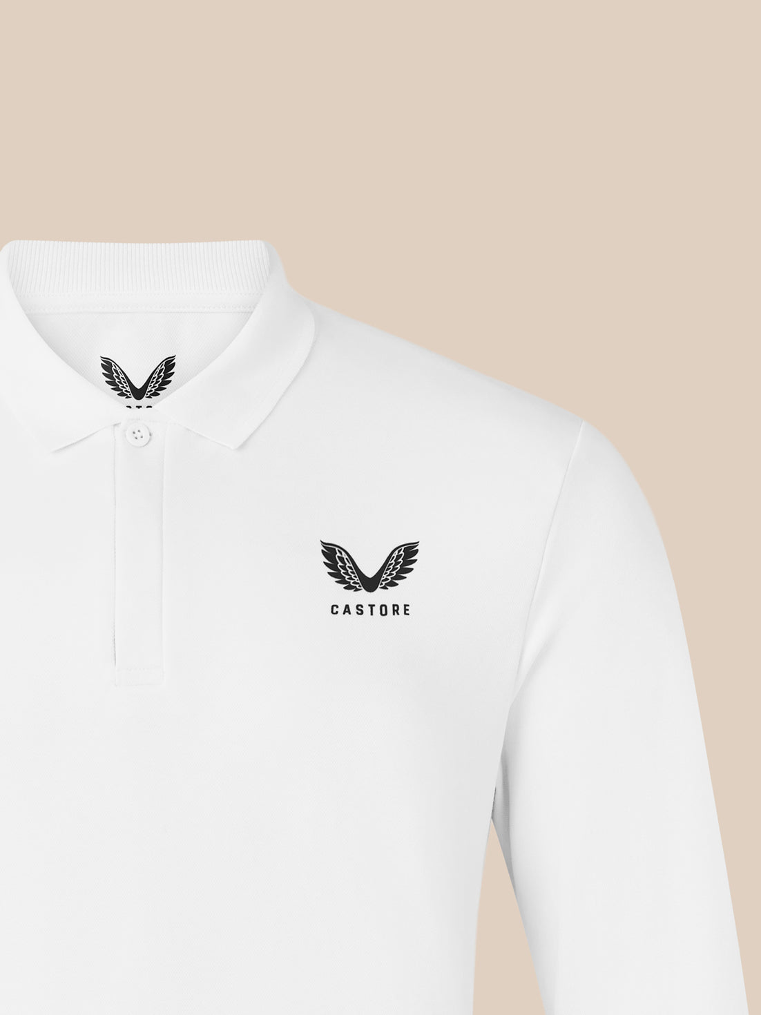 Close-up of white polo chest with wing logo and CASTORE text