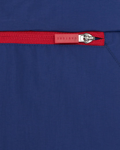 Close up of a red zipper on navy Rangers men's anorak fabric.