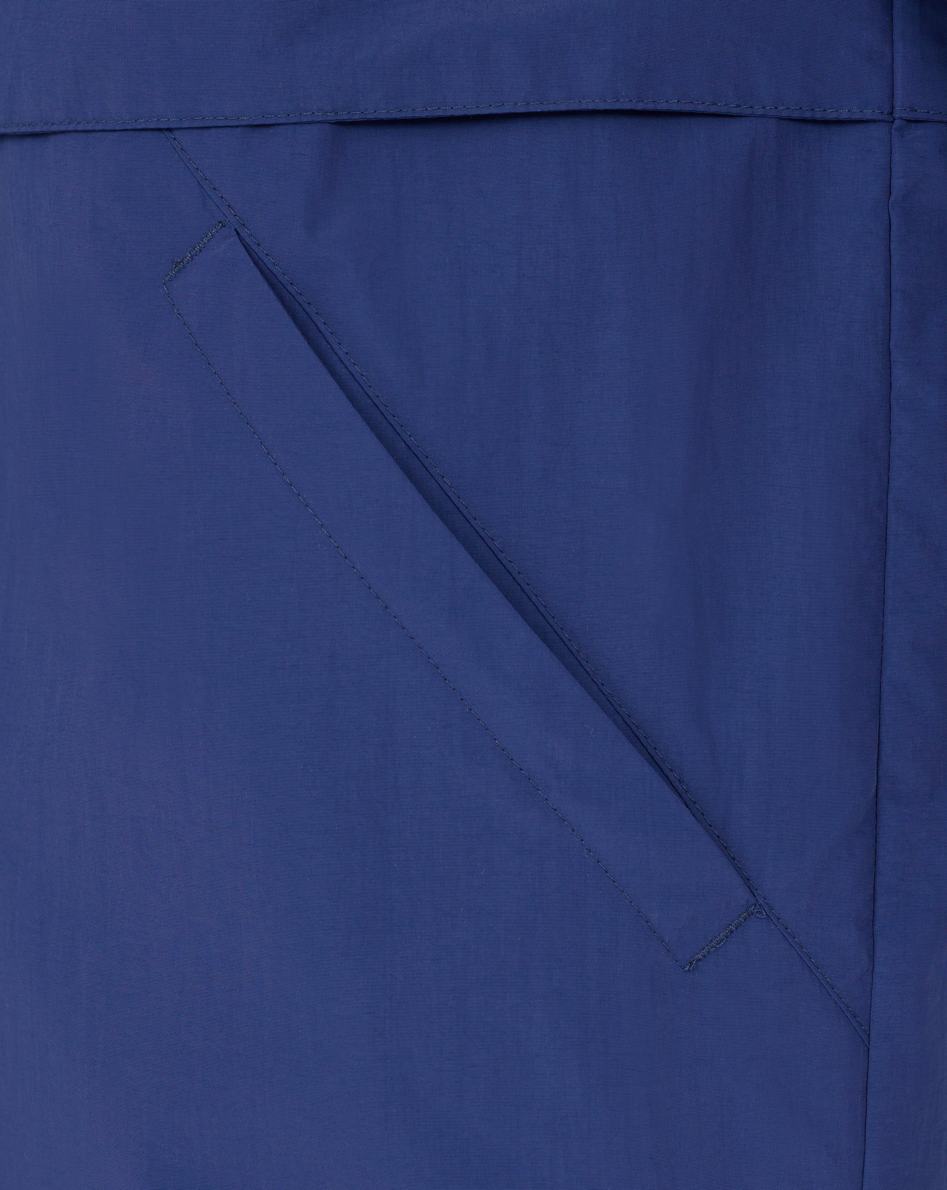 Close-up of blue Rangers Men's Anorak fabric showing a diagonal pocket seam and stitching.