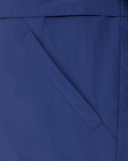 Close-up of blue Rangers Men's Anorak fabric showing a diagonal pocket seam and stitching.