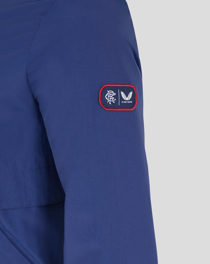 Close-up of a blue Rangers men's anorak sleeve with a red-edged patch showing the club emblem and Castore logo.