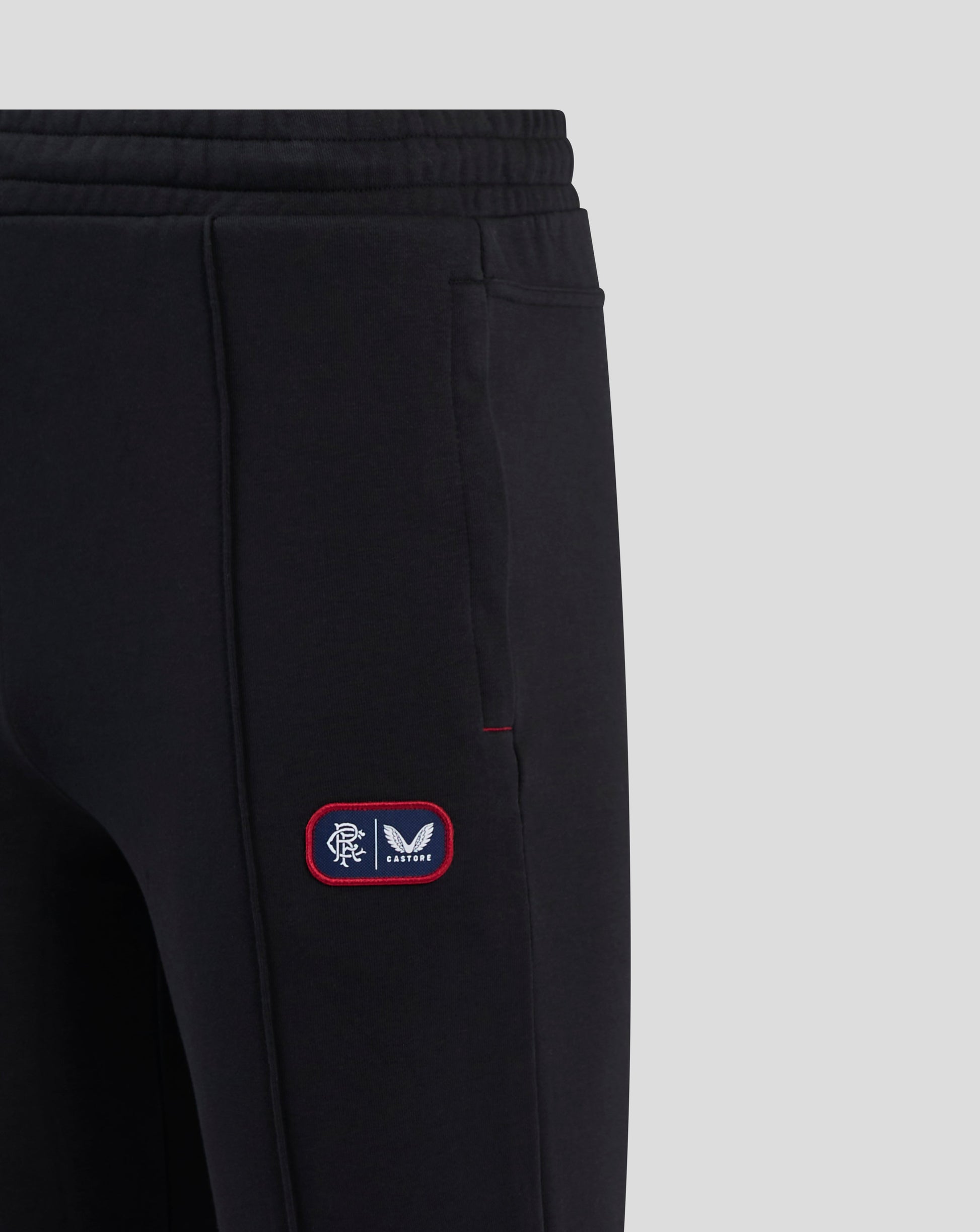 Back view of black Rangers joggers with a back welt pocket and badge on the left thigh.