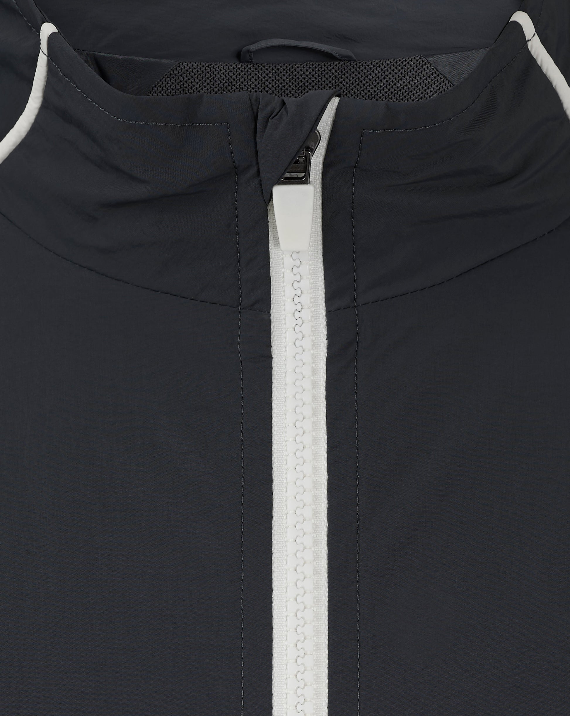 Back neck close-up of navy Rangers track jacket with white piping and exposed zipper