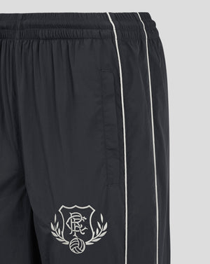 Close up of navy Rangers FC track pants showing elasticated waistband and full length white piping along the legs.