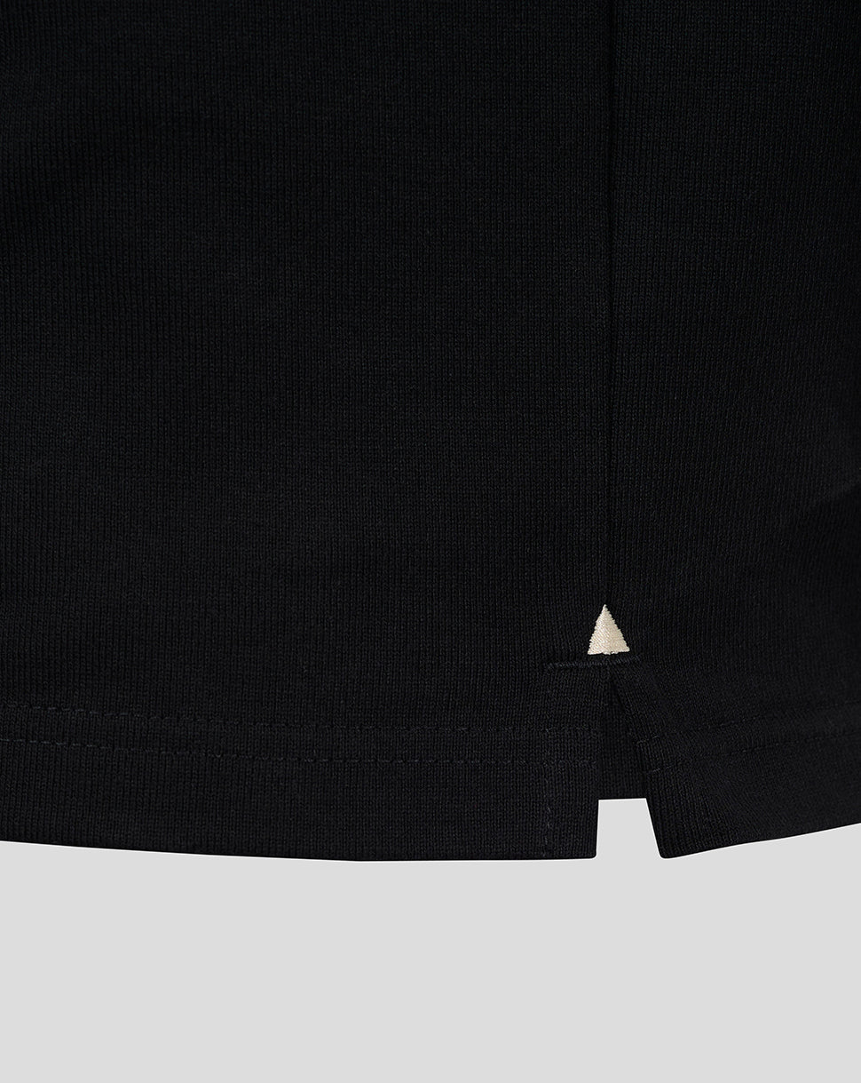 Black rugby jersey hem with small white triangle accent.