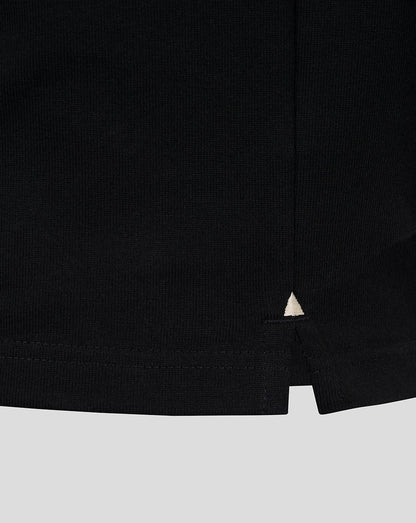 Black rugby jersey hem with small white triangle accent.