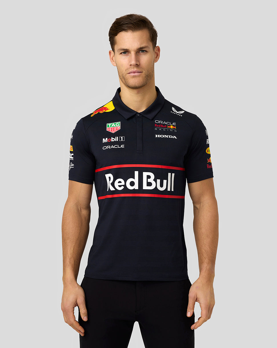 Front view of a model wearing a navy Red Bull Racing polo with a bold Red Bull logo across the chest and red accent stripes.