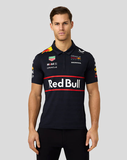 Front view of a model wearing a navy Red Bull Racing polo with a bold Red Bull logo across the chest and red accent stripes.