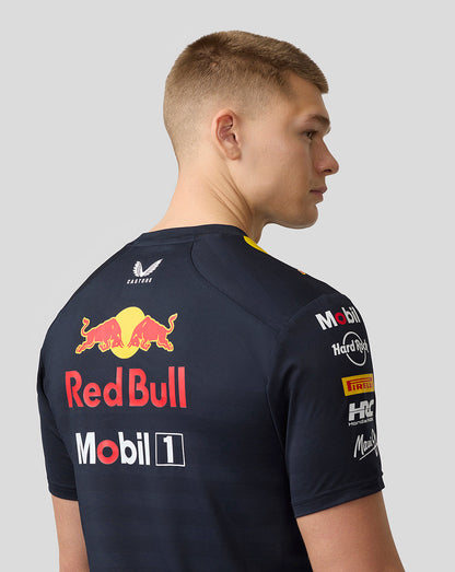 Back view of male model wearing navy Red Bull Racing Set Up T Shirt showing large Red Bull logo and sponsor patches