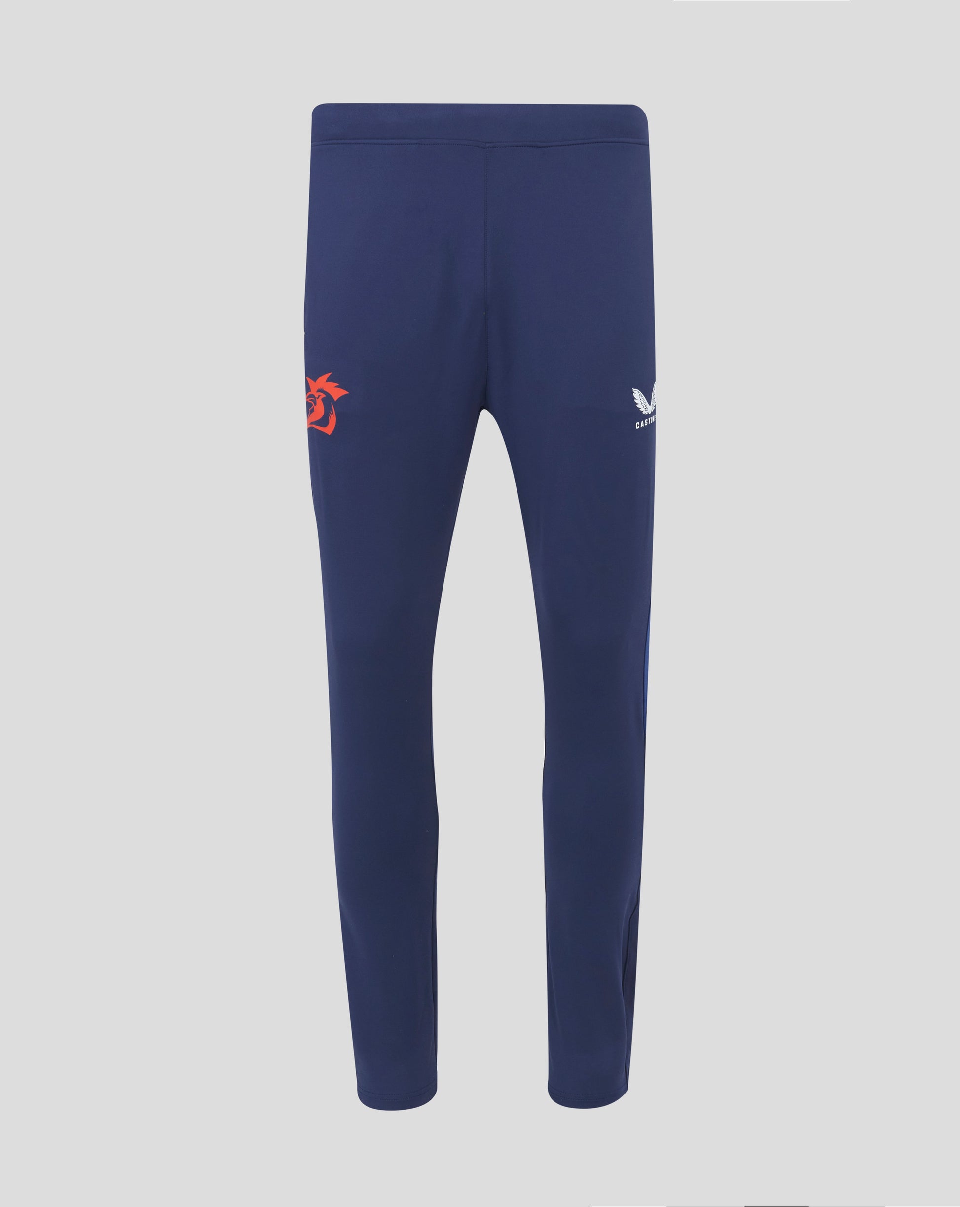 Rear view of navy training pants with an orange rooster emblem on the left leg and a white Castore logo