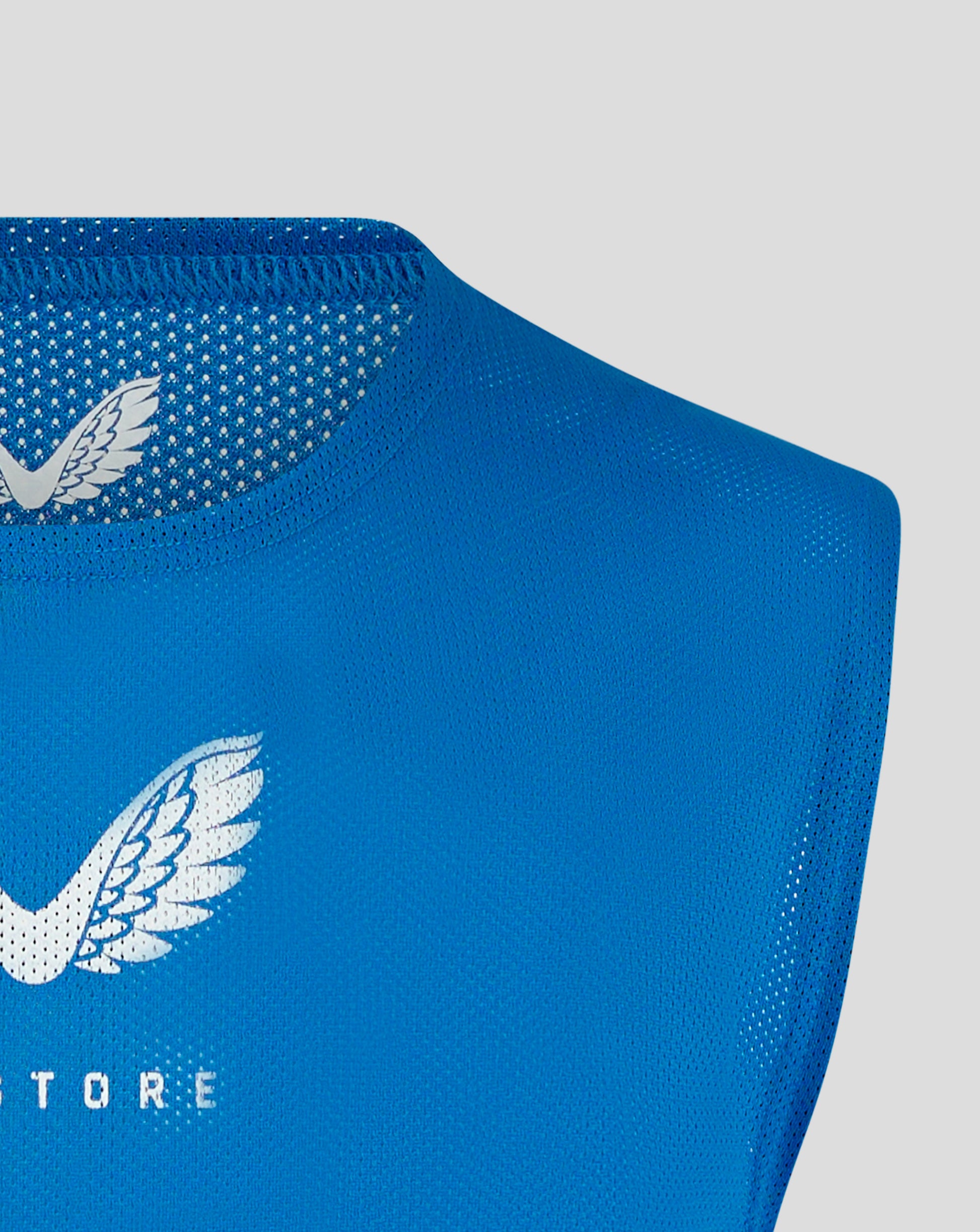 Blue mesh training bib with perforated panels and partial white logo