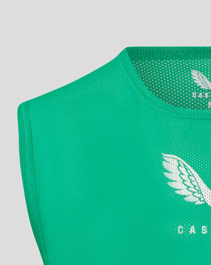 Green unisex training bib fabric close up with scoop neckline and binding at armholes