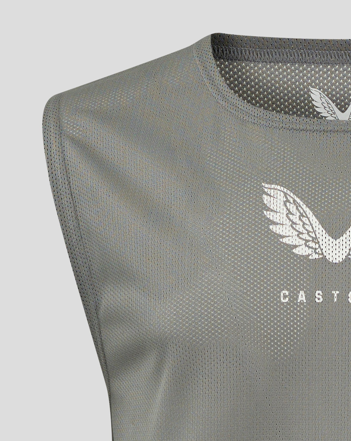 Close-up of Sharkskin junior training bib fabric showing scoop neckline and Castore logo.