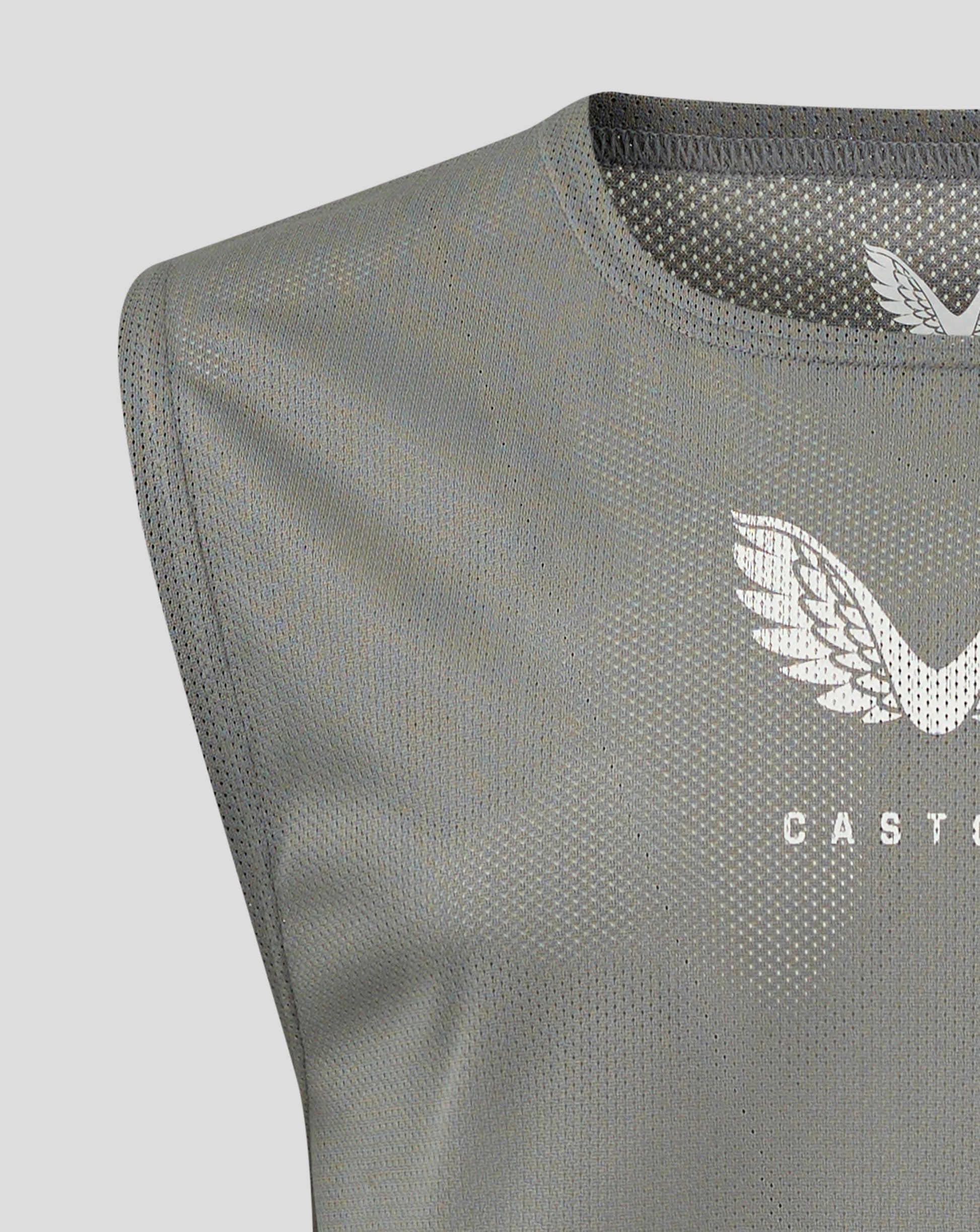Close-up of Sharkskin junior training bib fabric showing scoop neckline and Castore logo.
