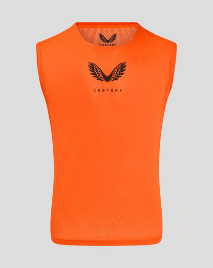 Front view of bright orange junior training bib with Castore logo on chest
