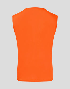 Back view of bright orange junior training bib showcasing breathable mesh fabric