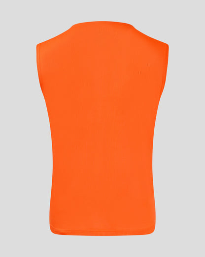 Back view of bright orange junior training bib showcasing breathable mesh fabric