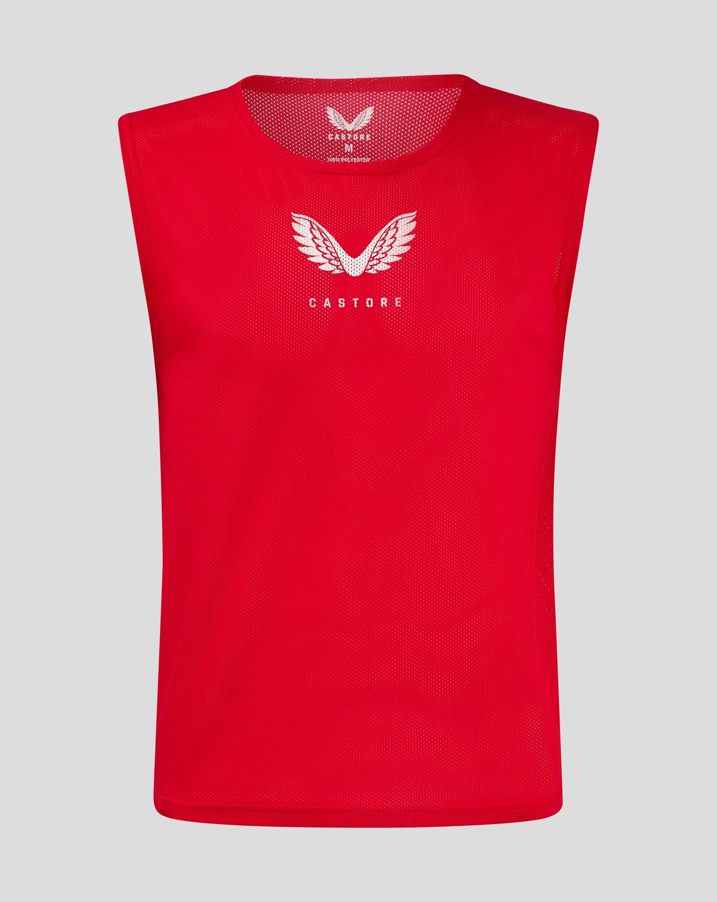Front view of red junior training bib with white Castore wing logo on chest.