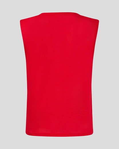 Back view of red junior training bib showing perforated mesh fabric.
