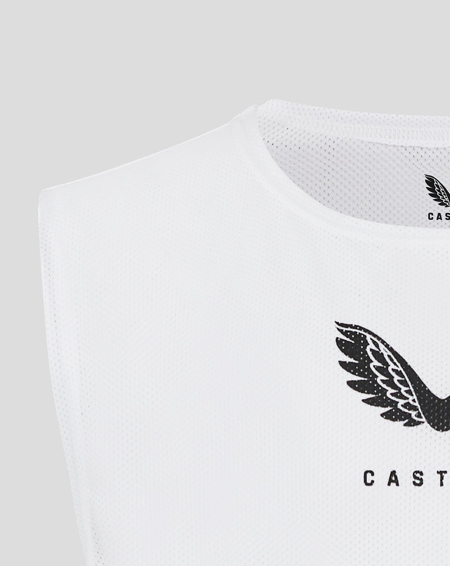Close up of white mesh bib around the neck with Castore logo